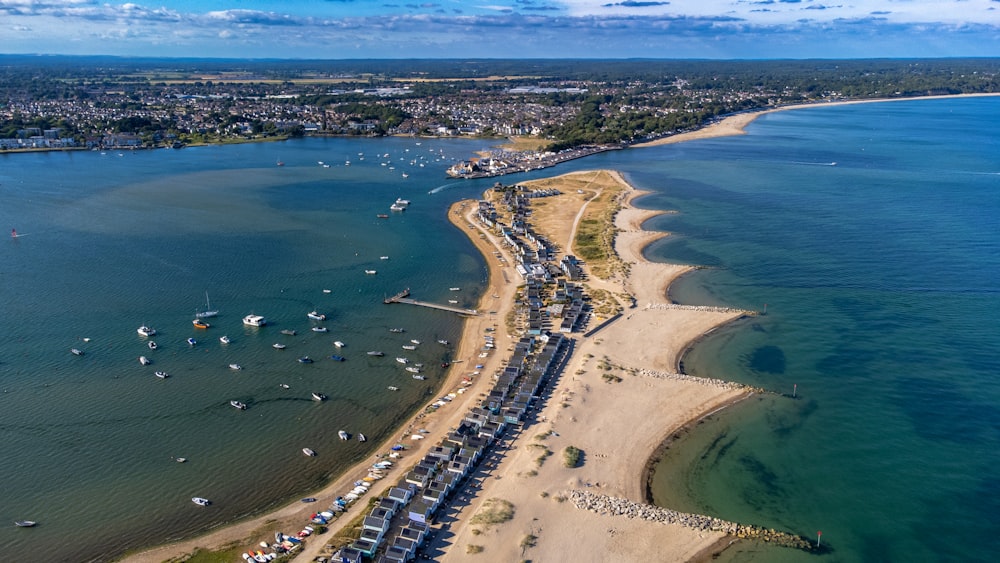 a beach with boats and people