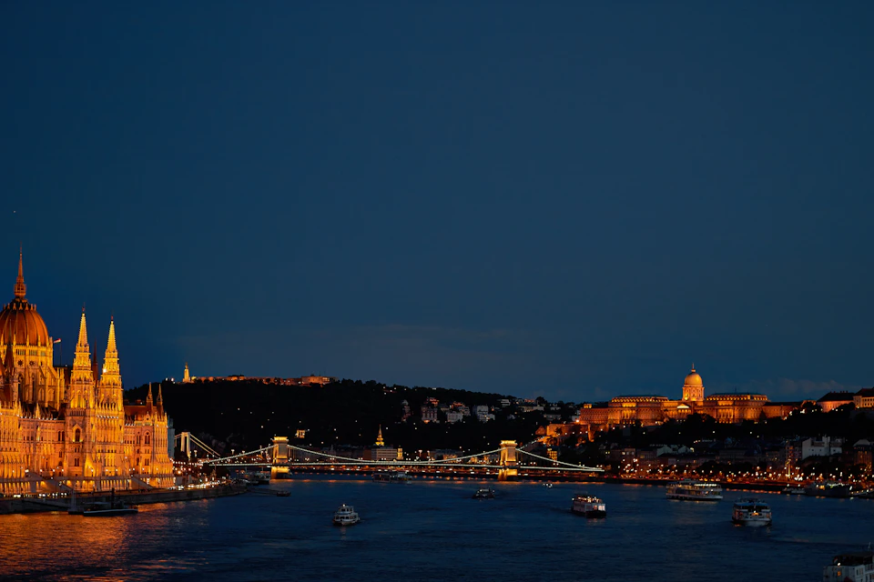 Serene night scene at Buda Castle in Budapest, Hungary, illuminated by warm yellow lights
