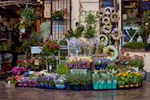 a store front with many flowers