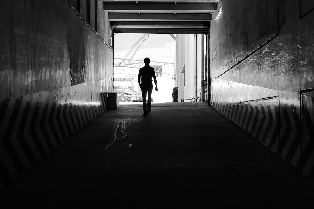 a man walking in a dark room