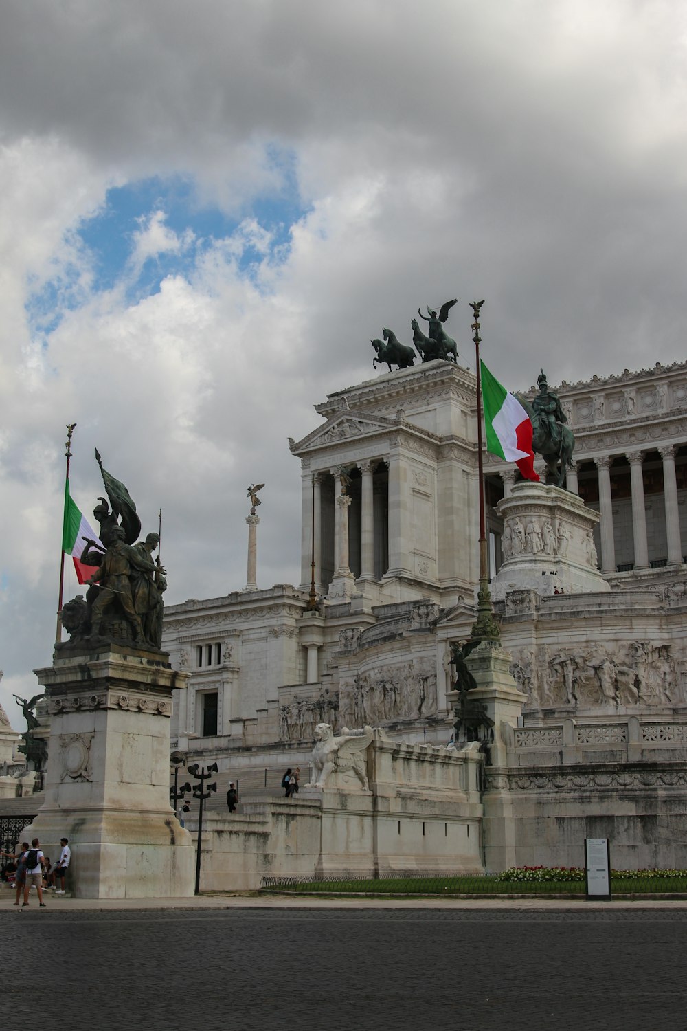 a building with statues and flags