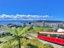 a red train on a track with Wellington Cable Car in the background