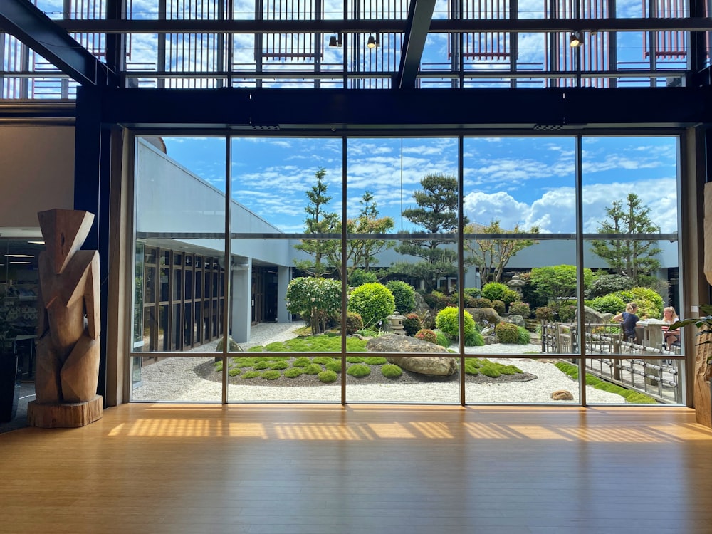 a large glass room with a large window and plants