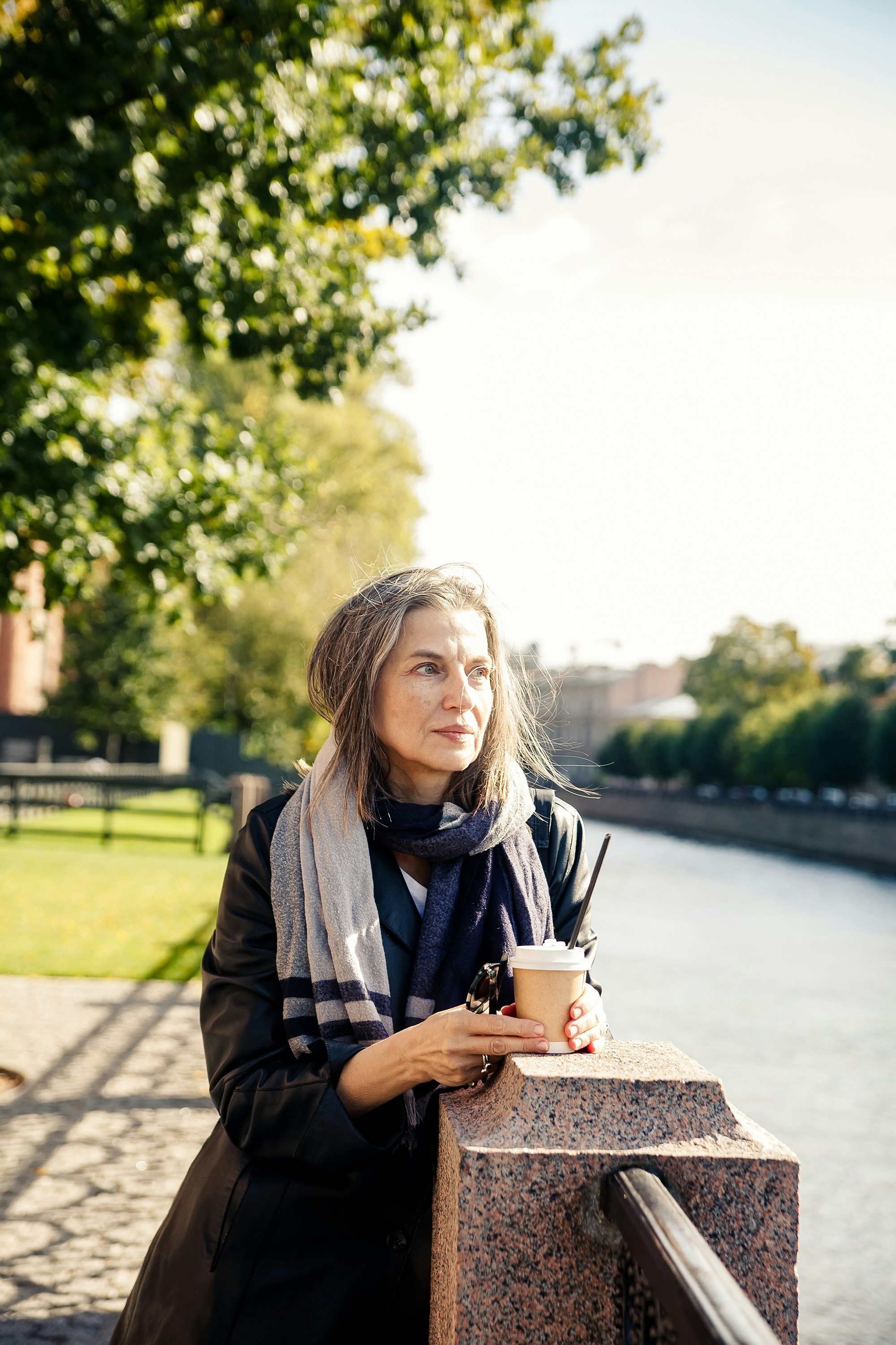 a woman holding a cup of coffee
