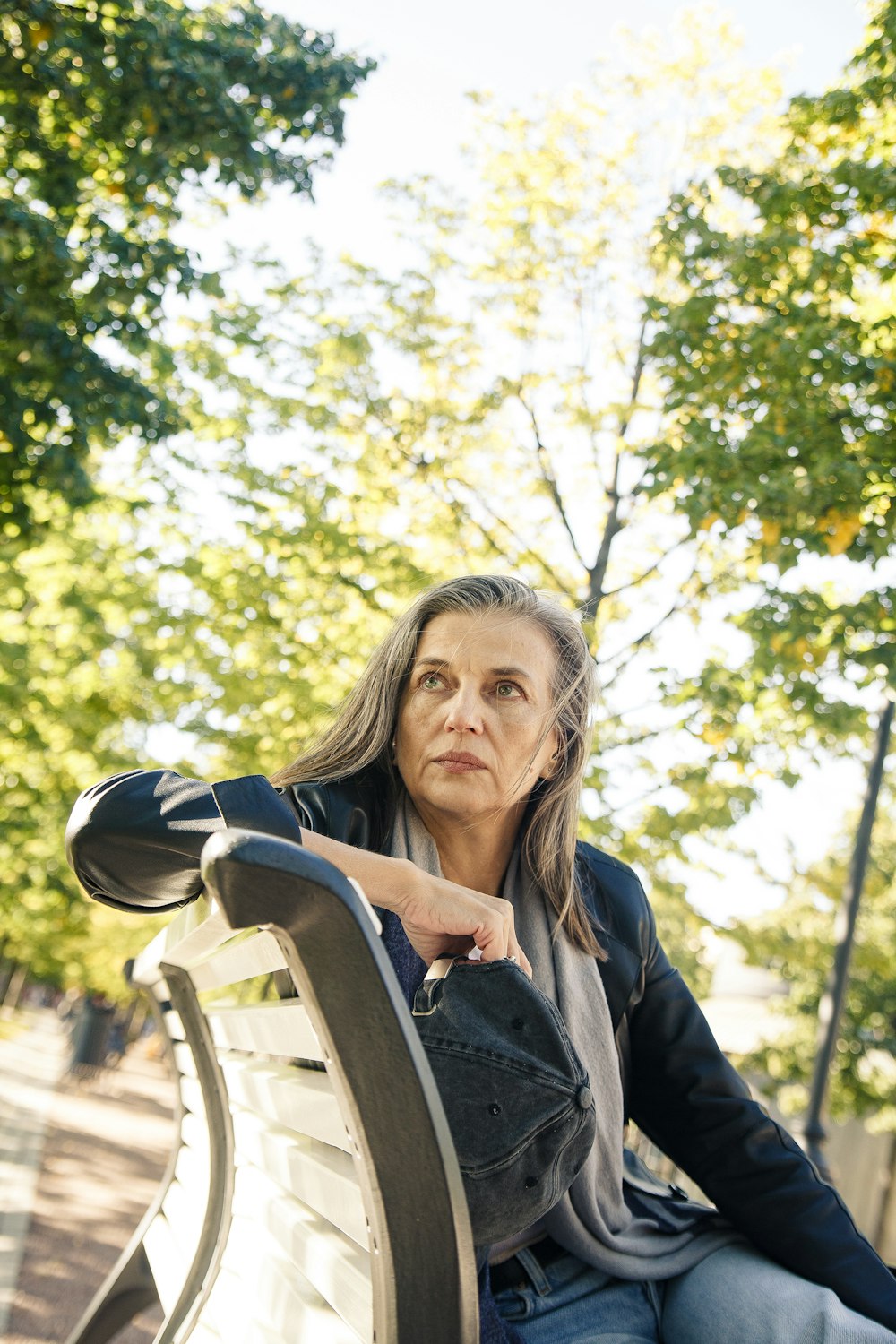 a person sitting on a white bench