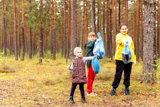 a group of children walking through a forest