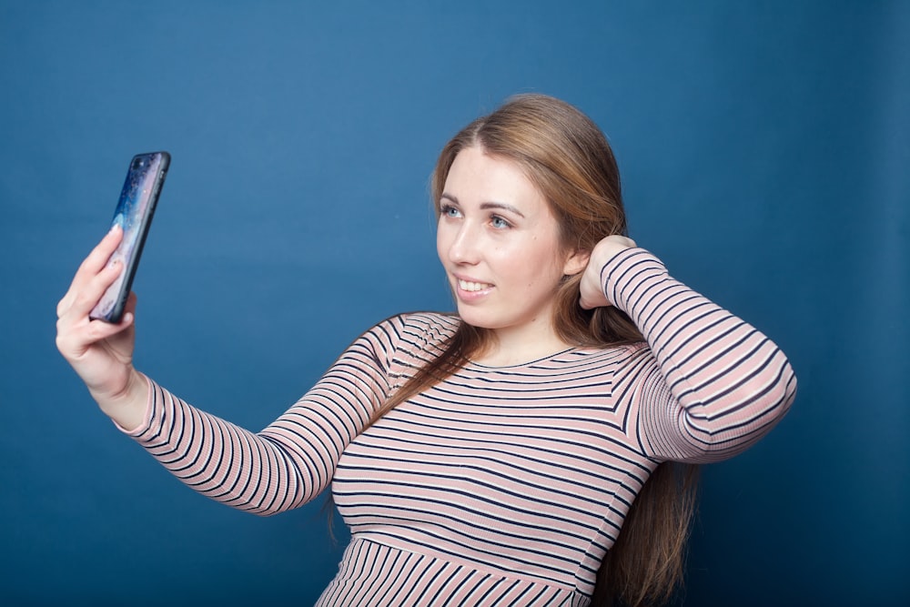 a woman holding a phone