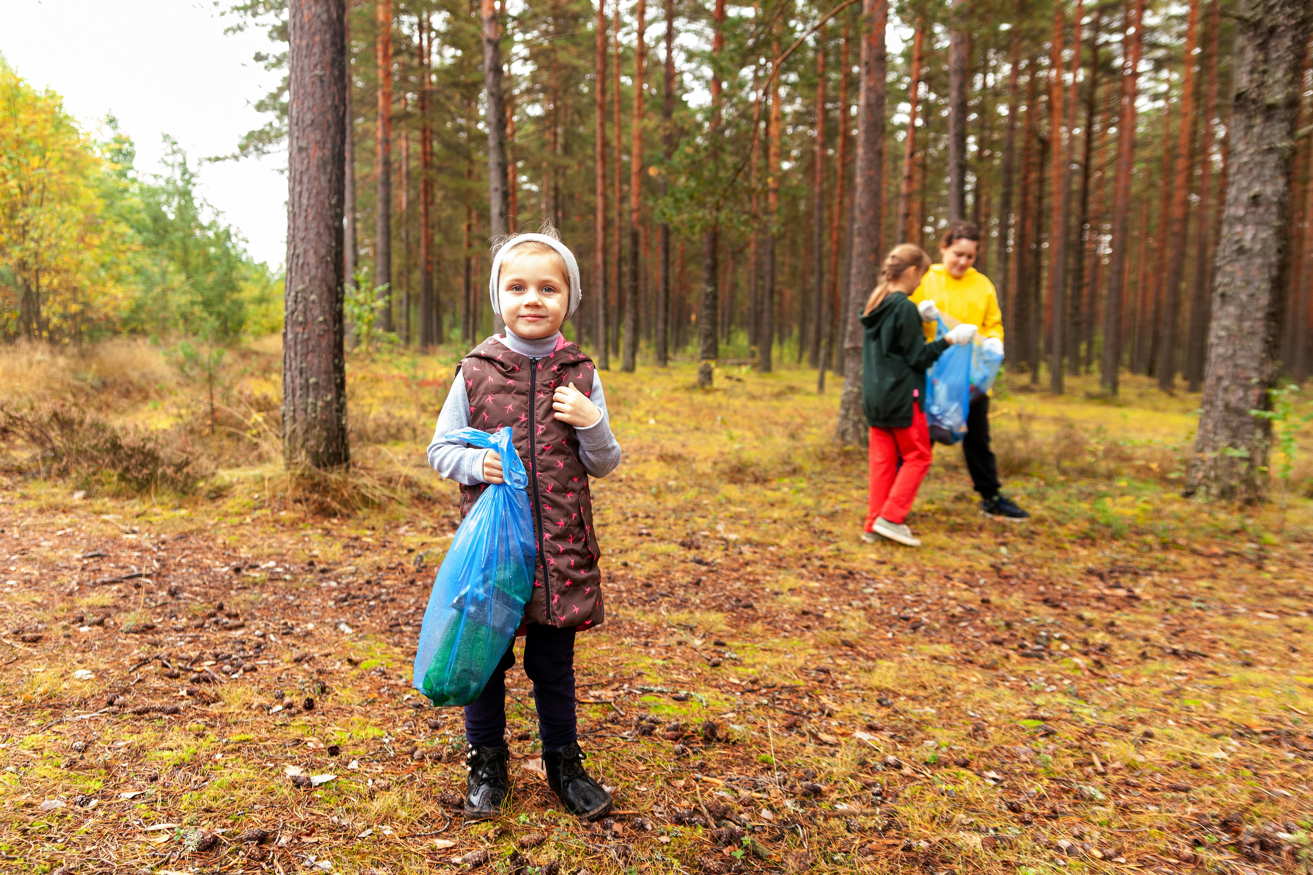 a group of people walking through a forest