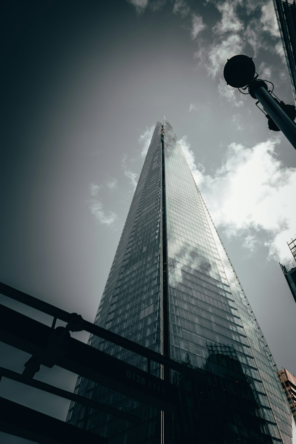 a tall building with a cloudy sky