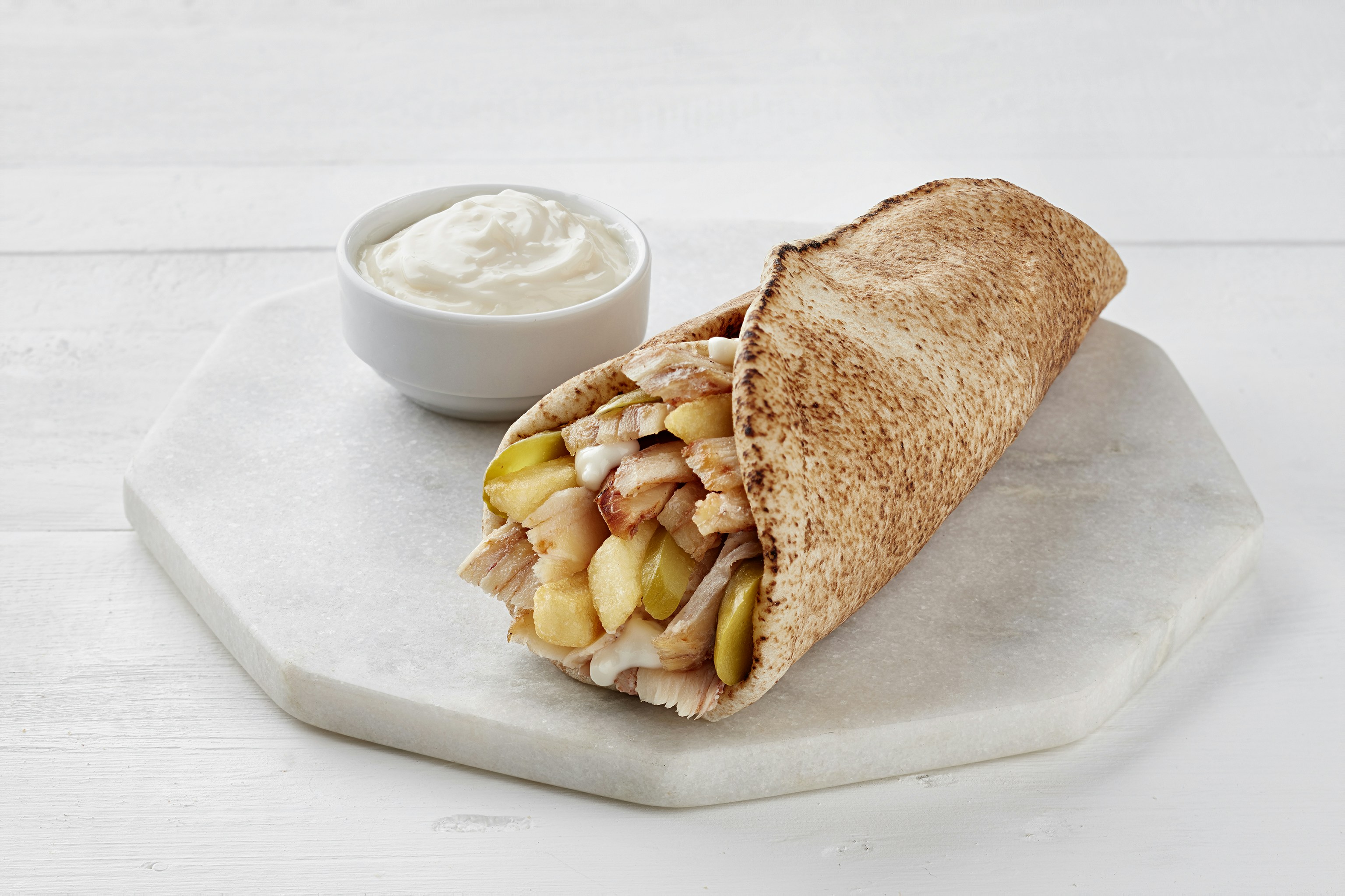 a sandwich with a side of dip