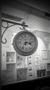 Vintage-inspired wall clock hanging above a wooden shelf with plants