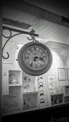 A cozy living room wall featuring a sleek digital clock and a classic round wall clock side by side.