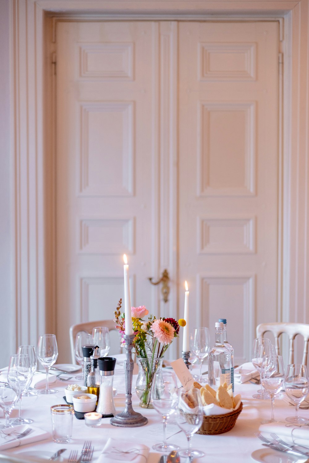 a table with a candle and glasses