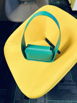 A chic handbag resting on a modern chair in a bright room.