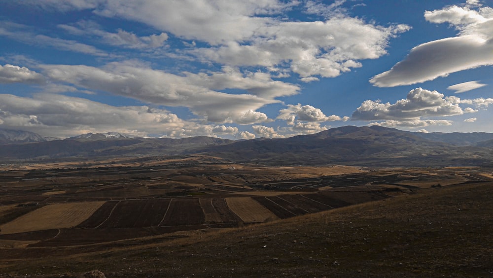 a landscape with hills and clouds