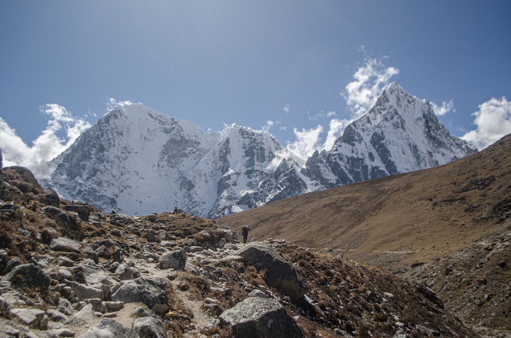 a person walking on a rocky mountain