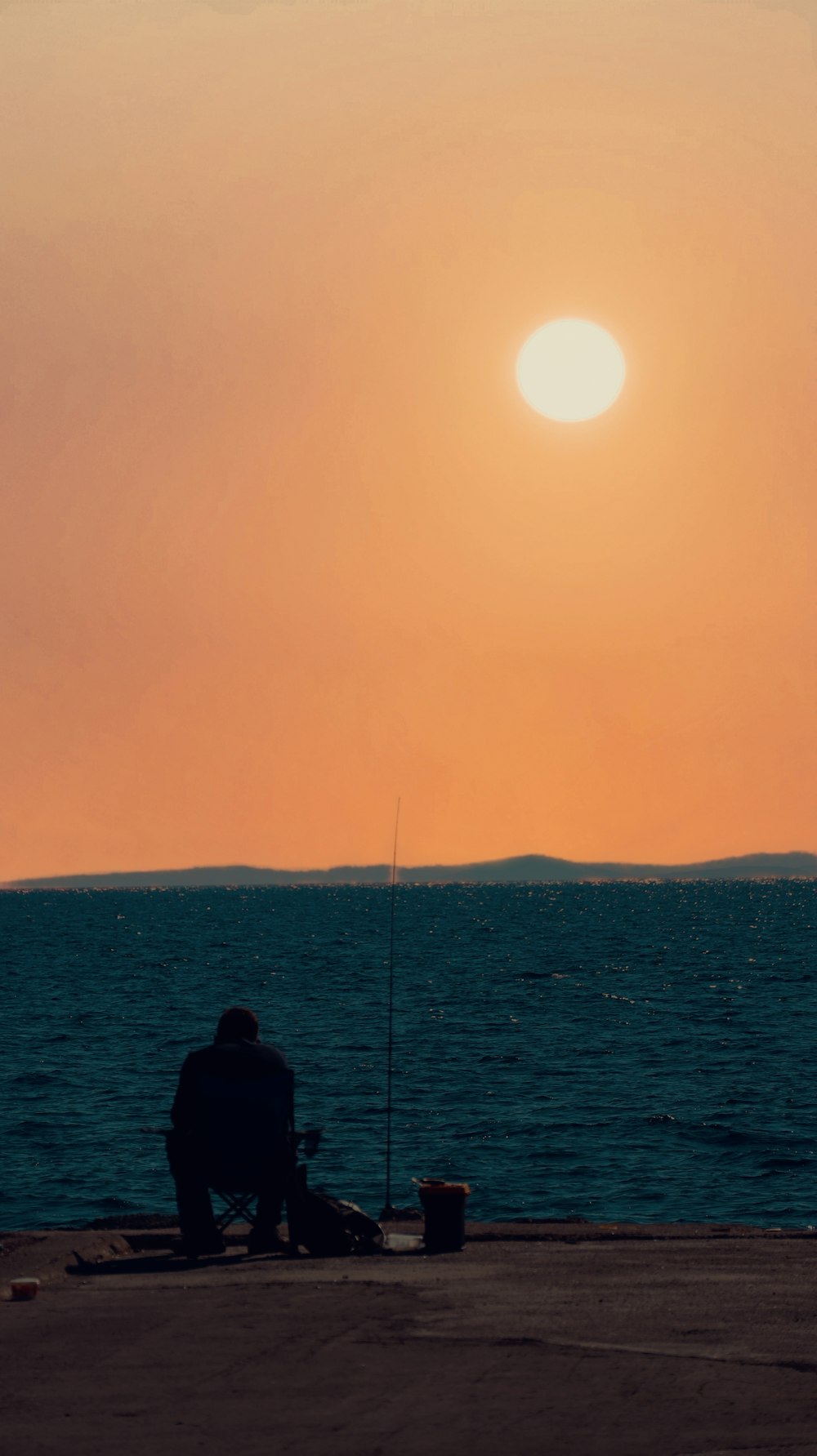 a person fishing on a beach