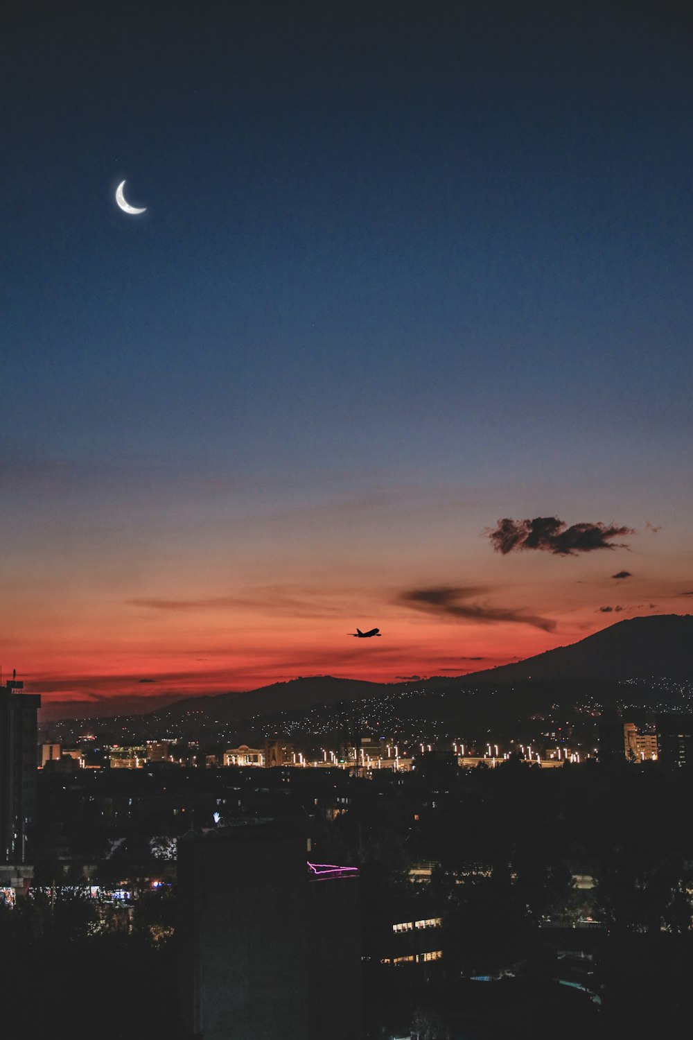 a moon in the sky over a city