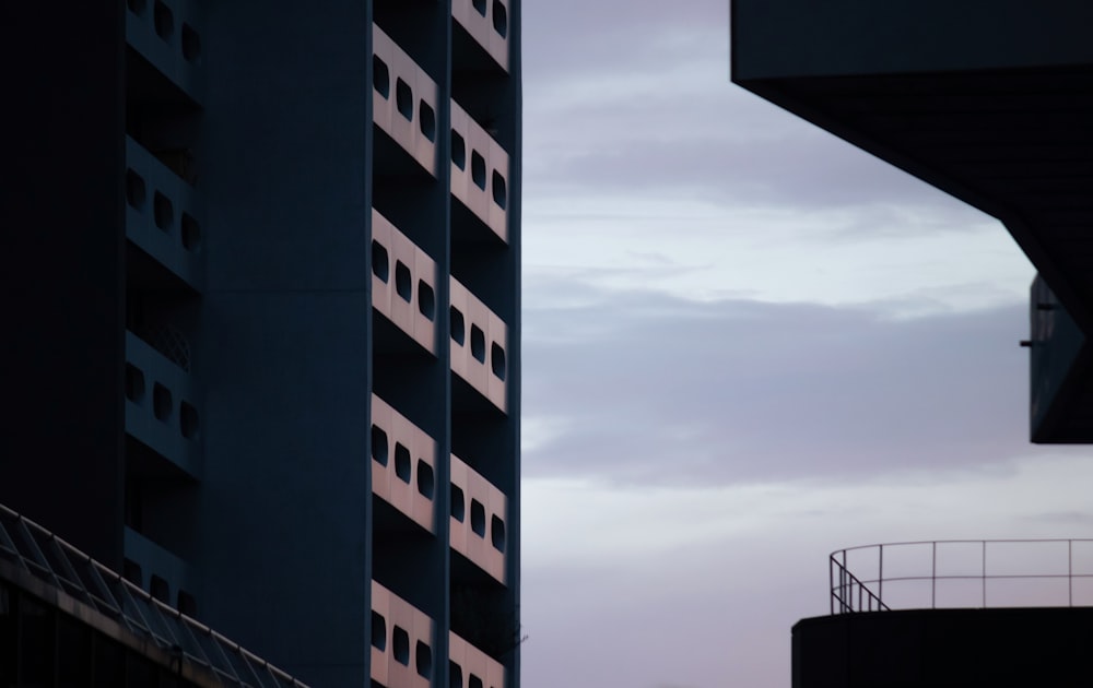 a tall building with a cloudy sky