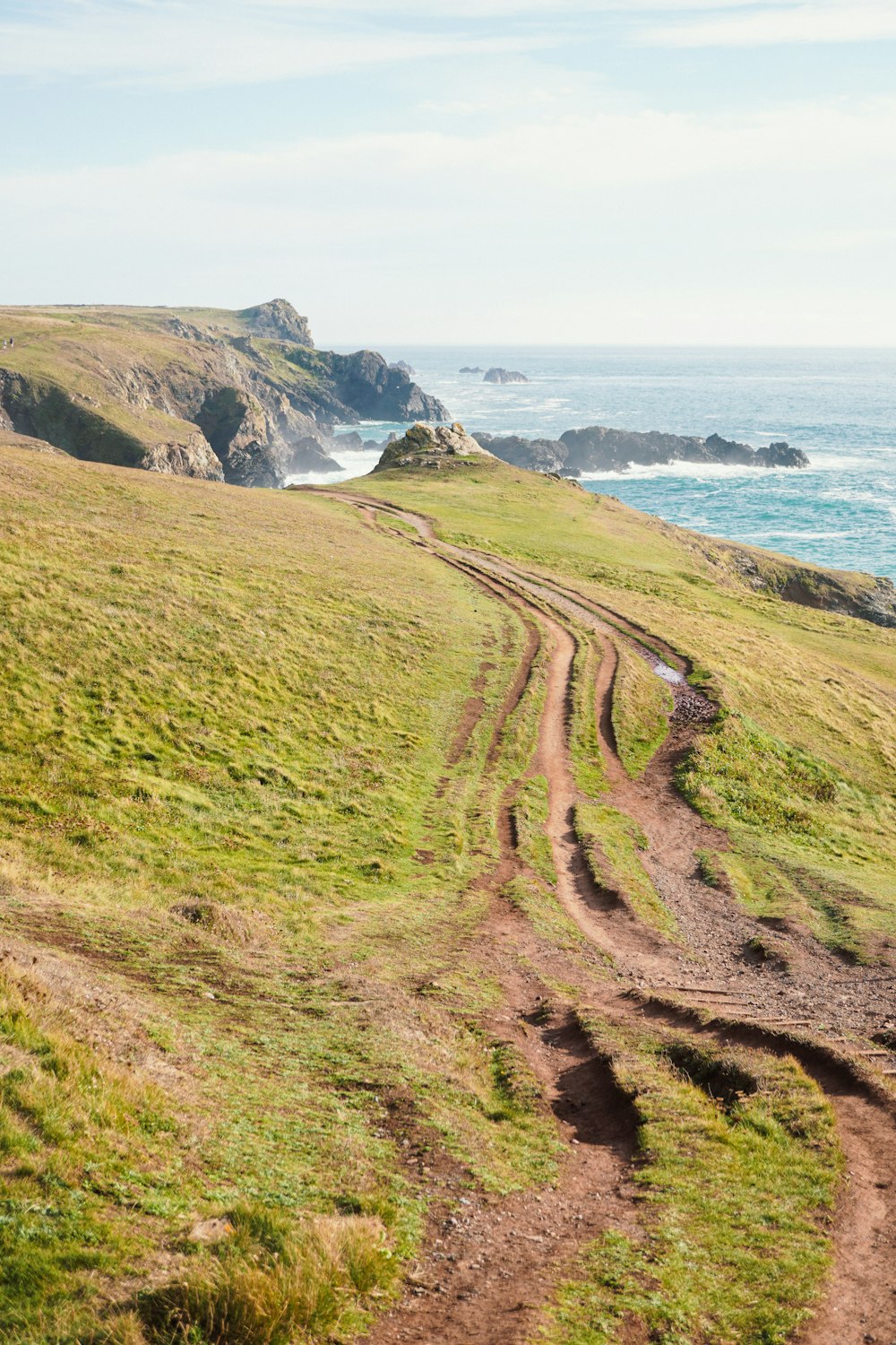 a dirt road leading to a beach