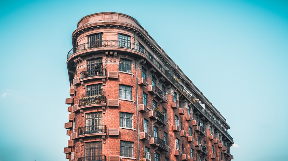 a tall building with balconies with Flatiron Building in the background