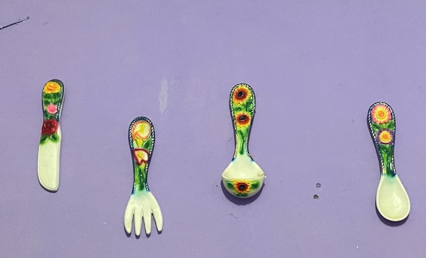 A set of colorful kitchen tools arranged neatly on a table.