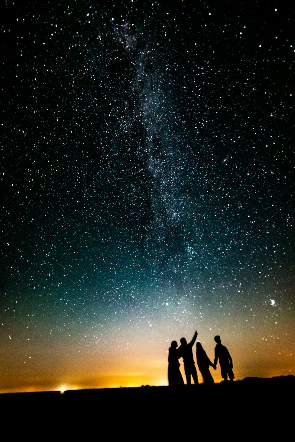 a group of people standing in front of a starry sky