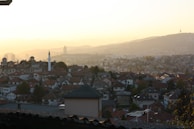 Sunset view over the rooftops of Casablanca with the Hassan II Mosque in the distance.