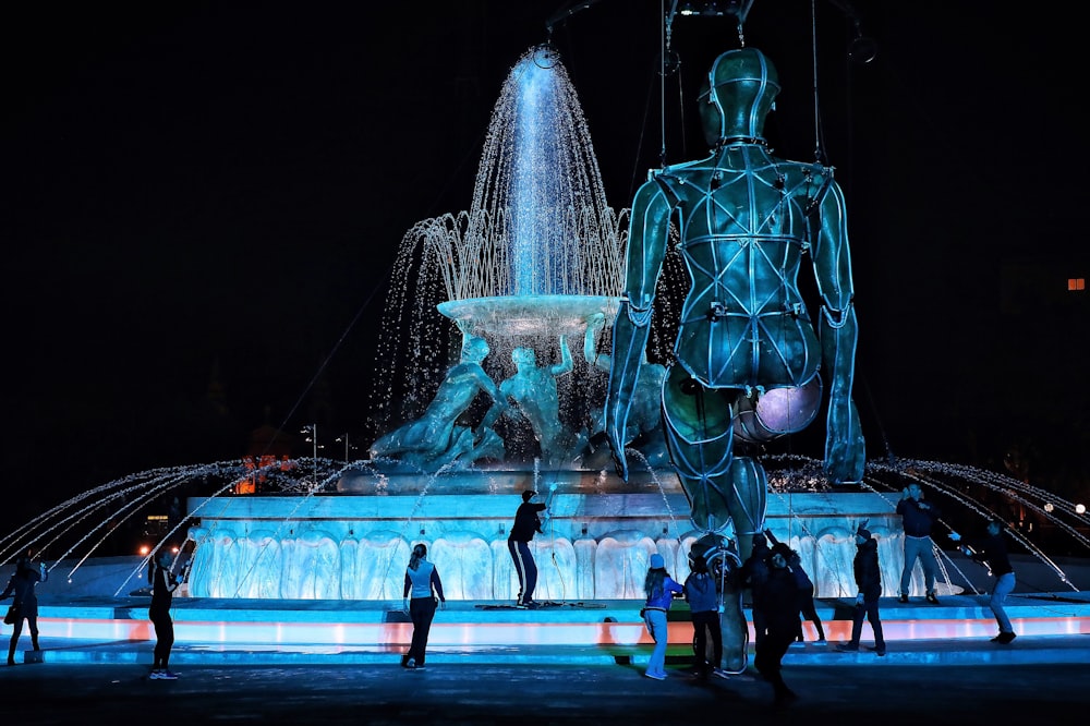 people standing around a fountain