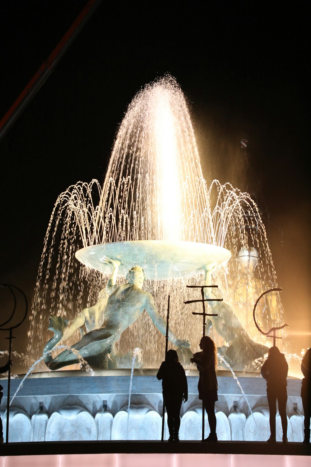 people standing in front of a fountain