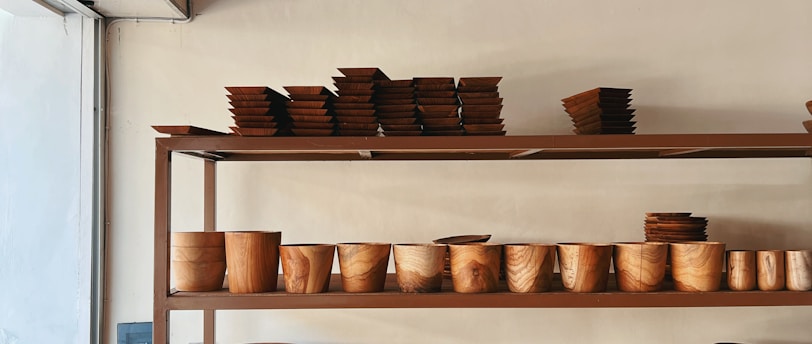 a shelf with many plates and bowls on it