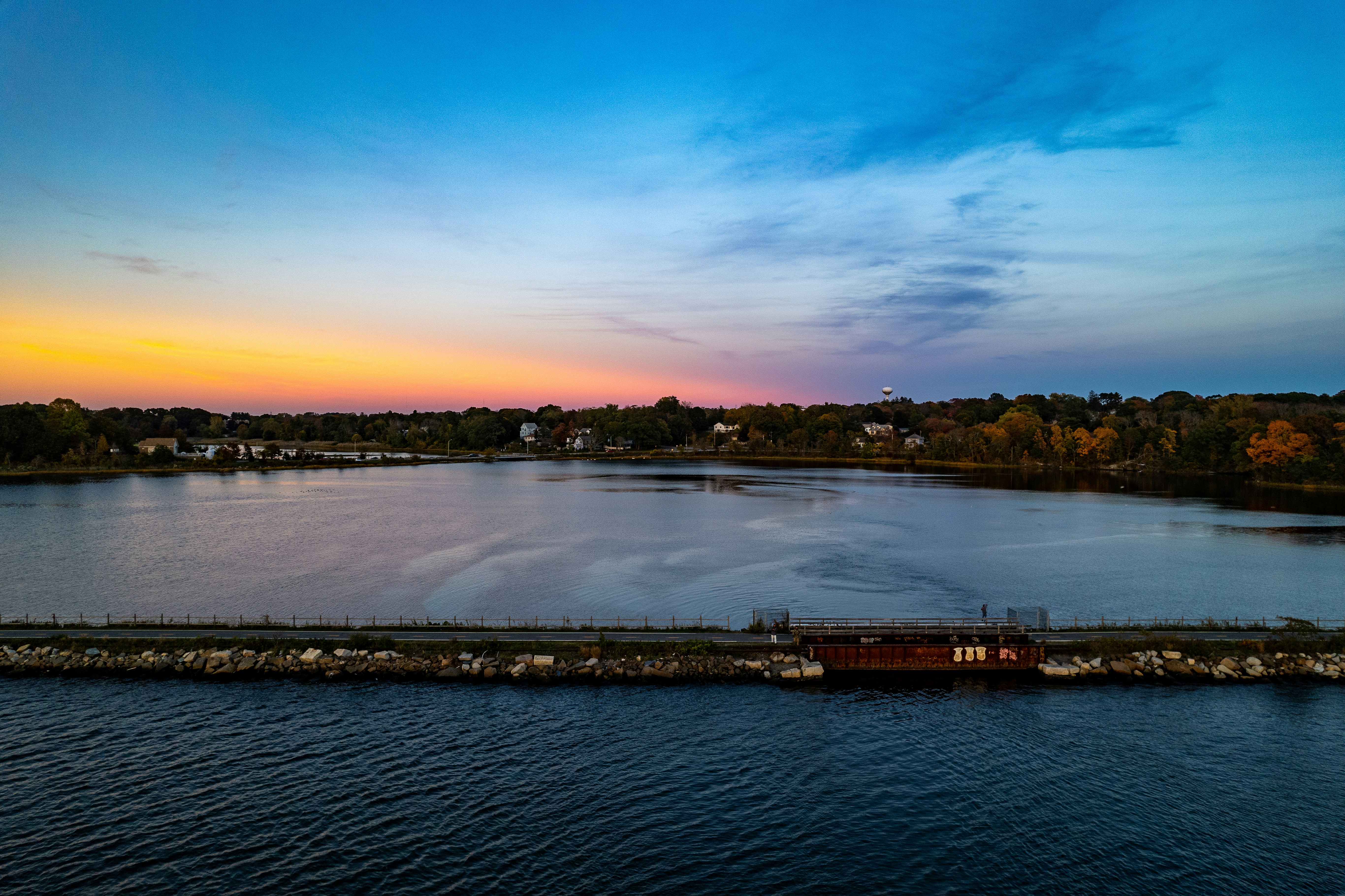 a body of water with a dock and a boat in it