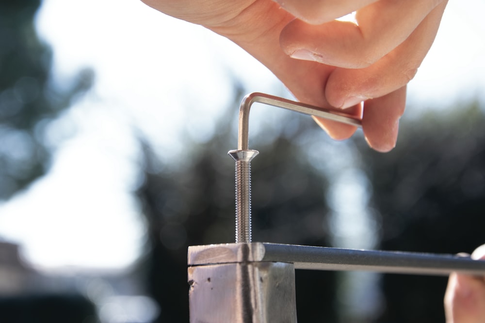 a close-up of a hand holding a metal rod