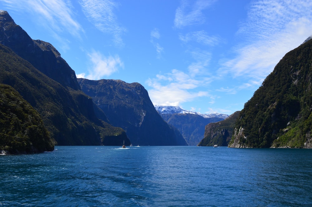 a body of water with mountains in the back