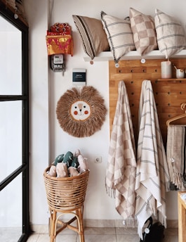 A cozy, pastel-toned nursery corner with handmade toys and organized shelves.