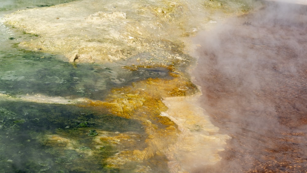 a body of water with a beach and waves