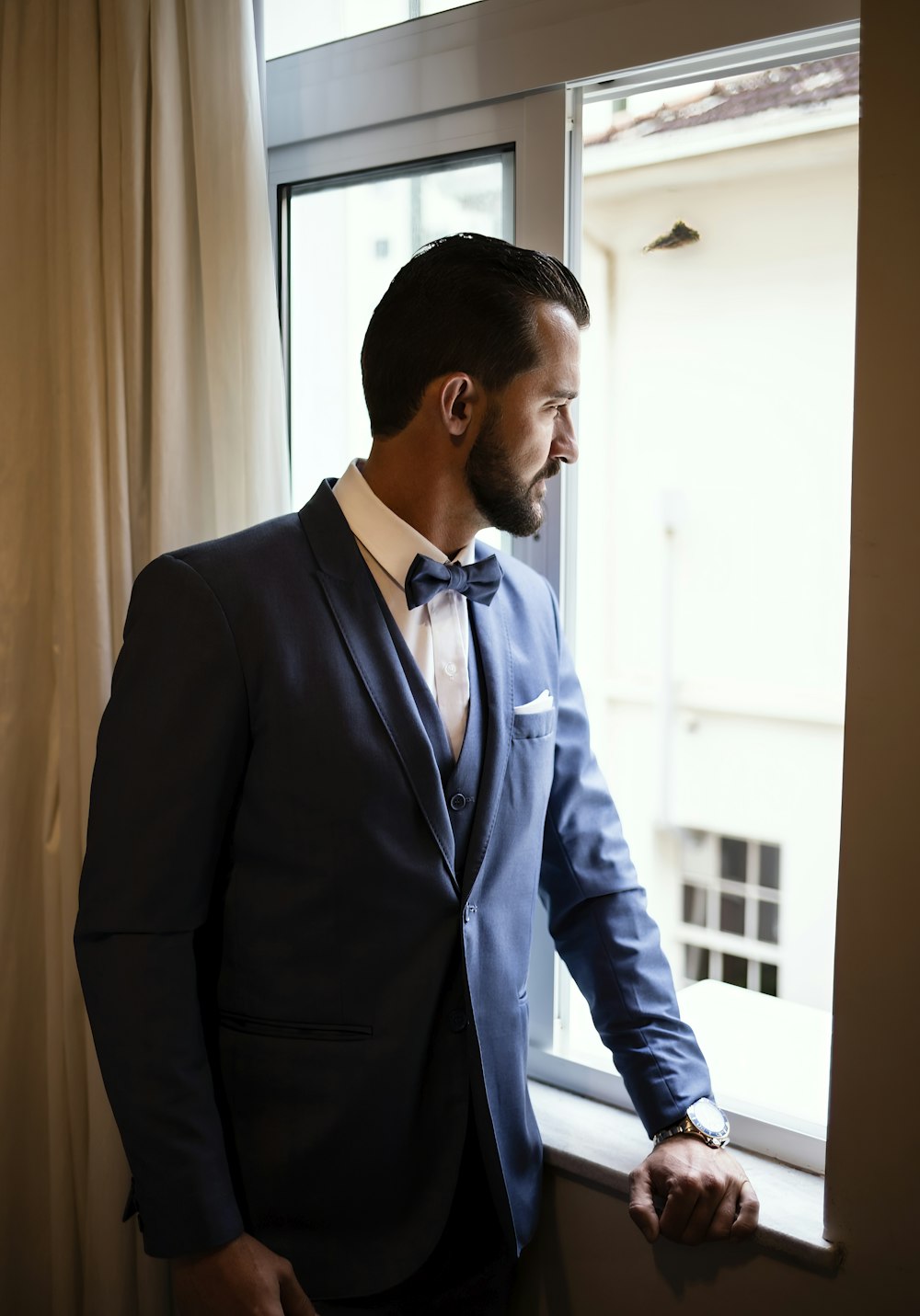 a man in a suit and bow tie