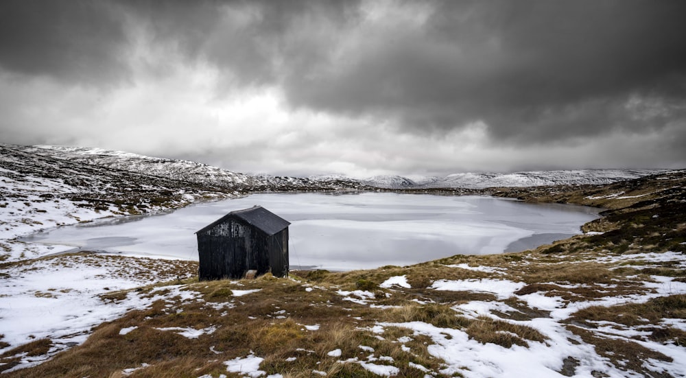 a small shack by a lake