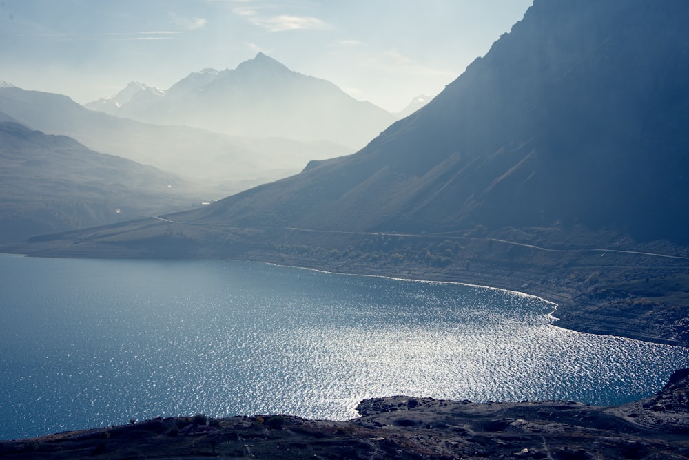 a body of water with mountains in the background