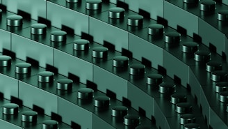 A close-up view of interconnected dark green building blocks with cylindrical connectors, arranged in diagonal rows, creating a repetitive and geometric pattern.