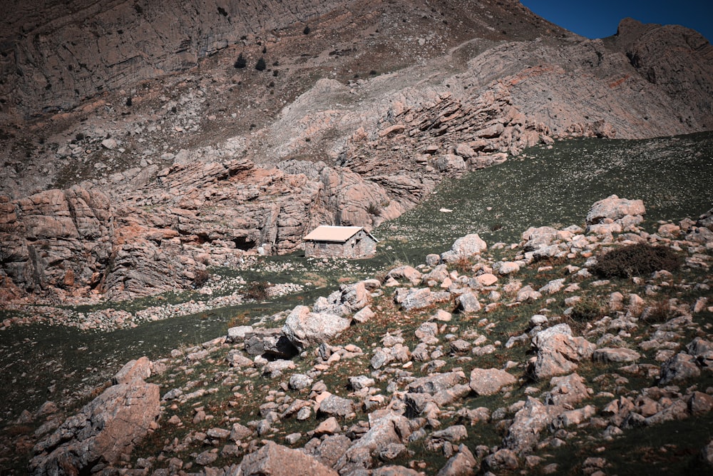 a rocky hillside with a building