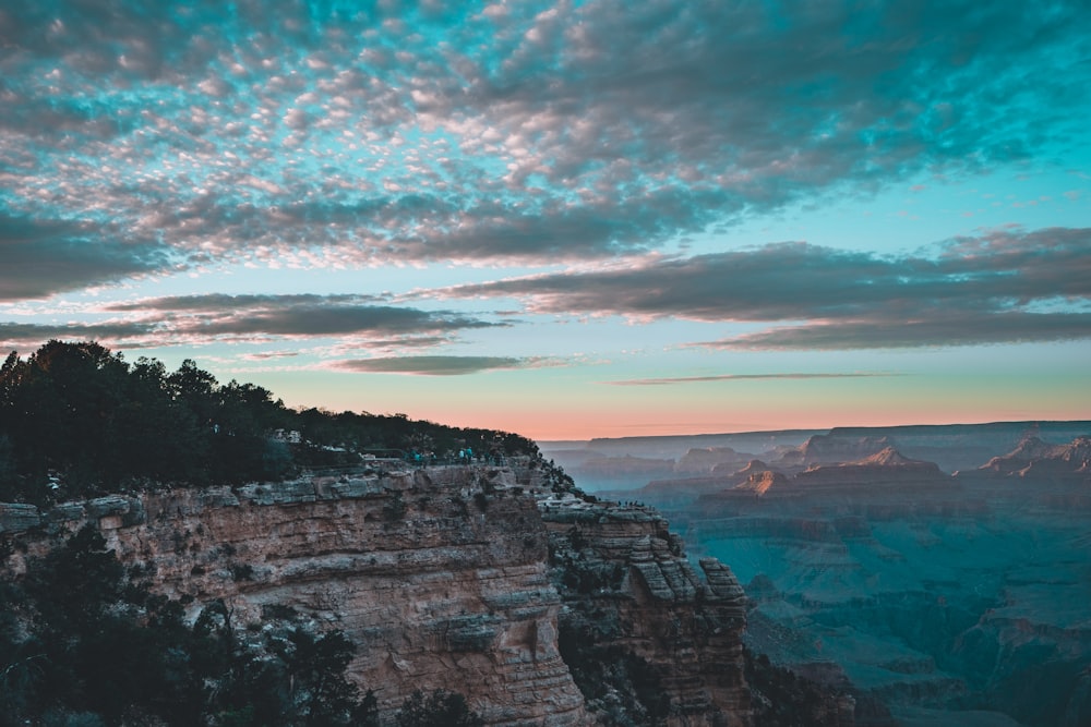 a cliff with a body of water below