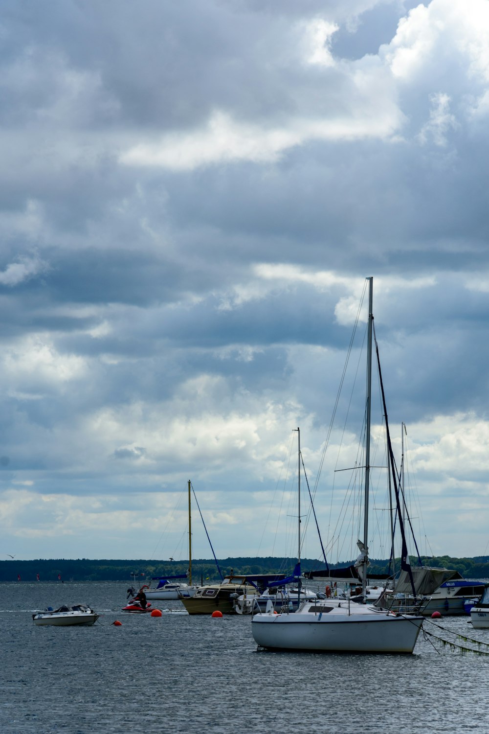 a group of boats sit in a harbor