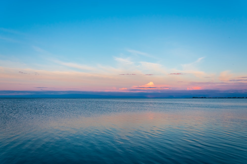 a body of water with a sunset