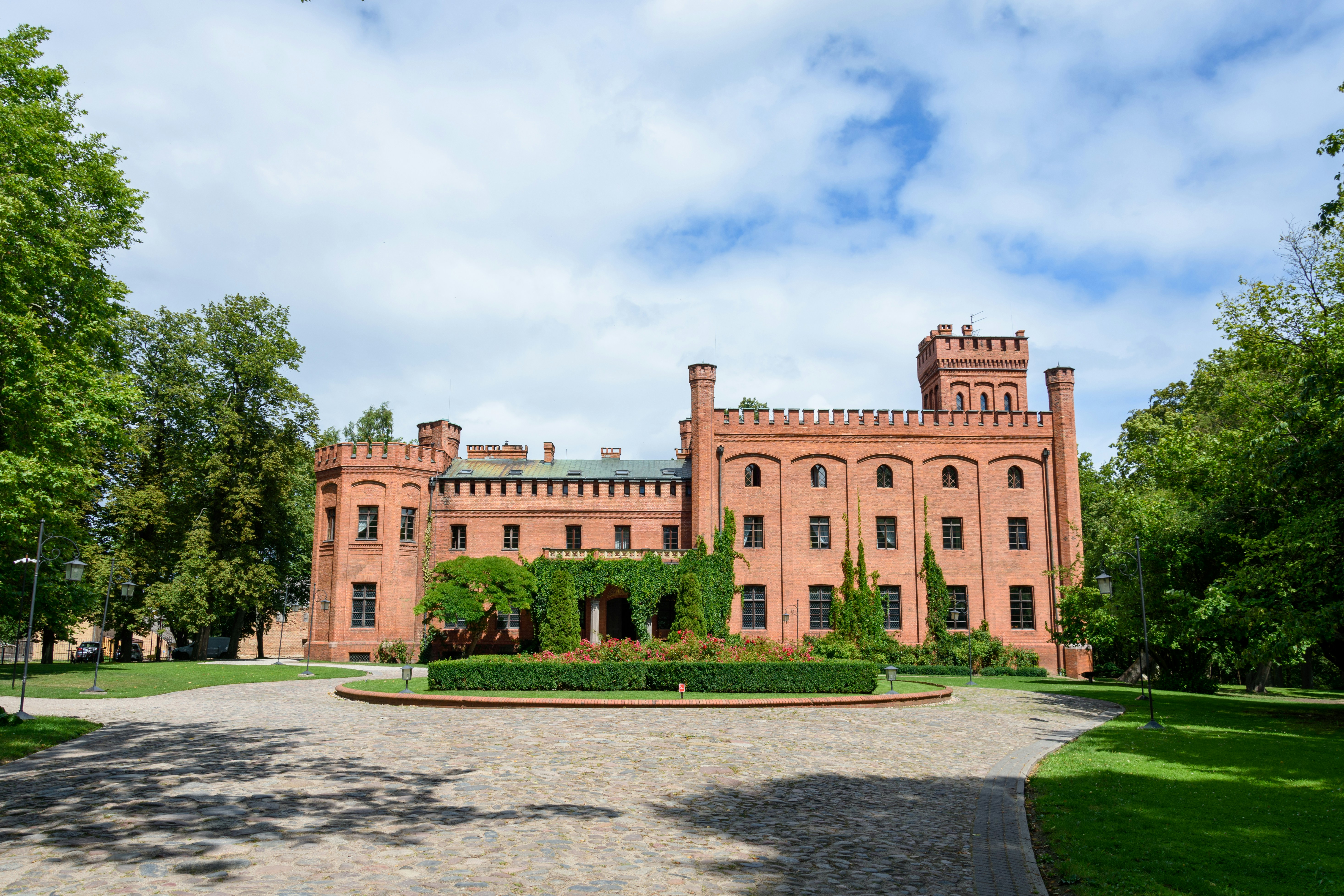 a large brick building with trees around it