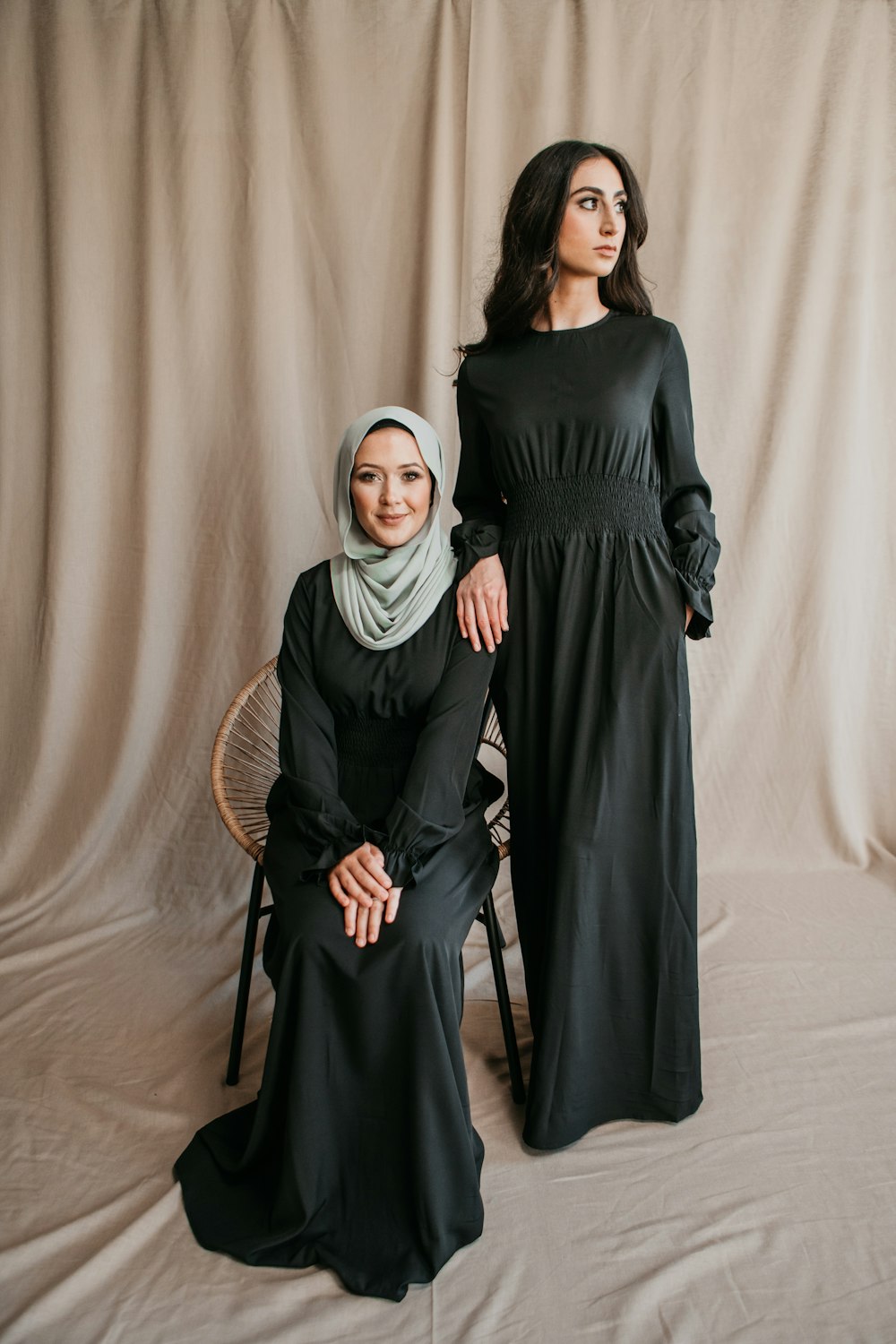 two women in black dresses