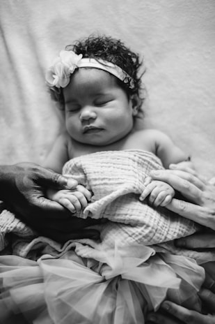 a baby sleeping on a blanket