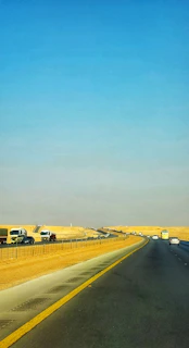 A wide shot of a freshly paved highway cutting through a desert landscape, showcasing Terraviva's infrastructure work.