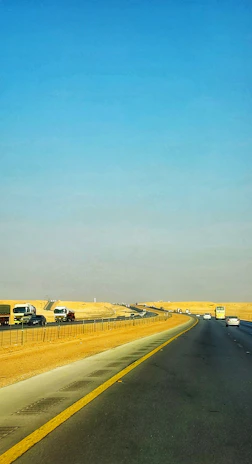 A wide shot of a freshly paved highway cutting through a desert landscape, showcasing Terraviva's infrastructure work.