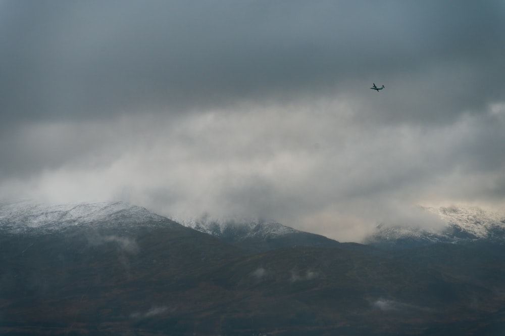 a plane flying over a mountain